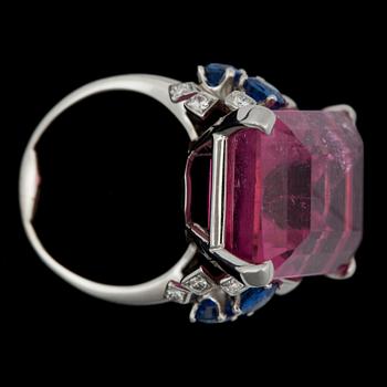 A 24.00 cts pink tourmaline, 0.50 ct sapphire and 0.30 ct diamond ring.