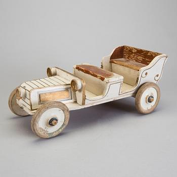 A painted wooden toy car c. 1910.