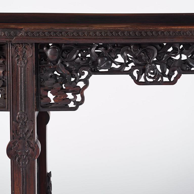 A massive zitan recessed-leg long table 'Jiaotousun Qiotouan', Qing dynasty, 19th century.
