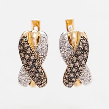 A pair of 14K white/yellow gold earrings, with clear and brown diamonds totaling approximately 0.40 ct.