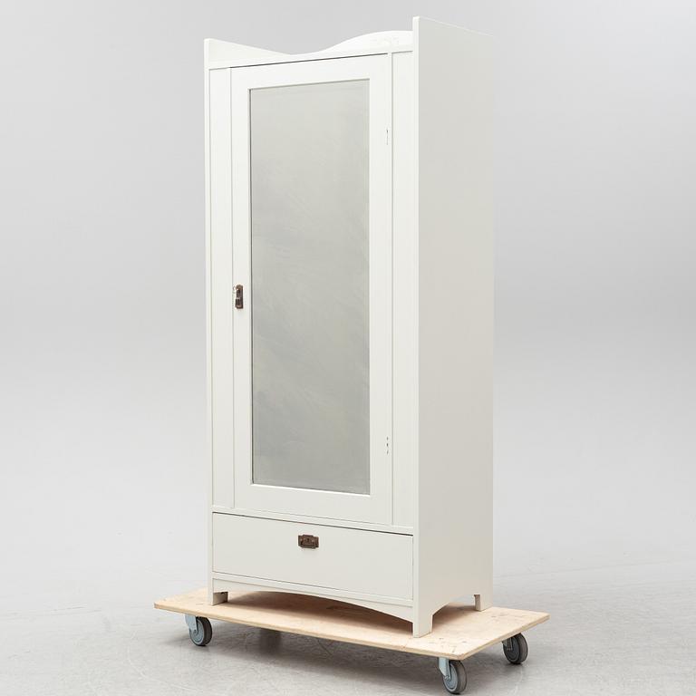 An early 20th Century painted clothes cabinet.