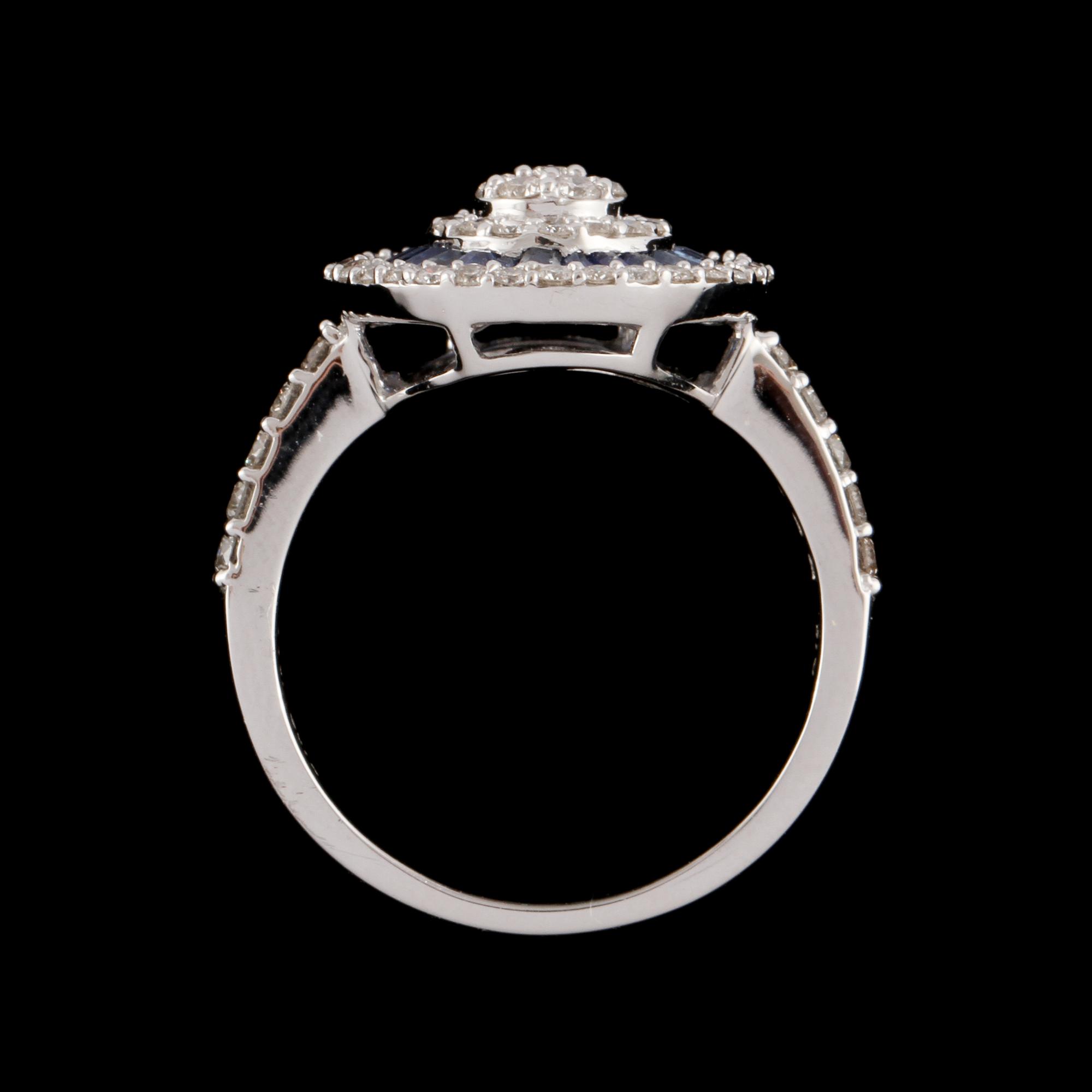 RING, 18k vitguld med 63 briljantslipade diamanter, tot  0.67 ct, samt 24 blå safirer, tot 0.72 ct. Vikt 5 g.