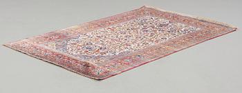 A RUG. A semi-antique silk Kashan. 205,5 x 131,5 cm.