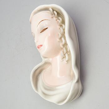 A late 1930s porcelain Goldscheider wall mask, model 7894, marked "Goldscheider Wien" and Made in Germany.