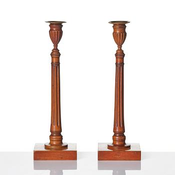 A pair of George III mahogany candlesticks, circa 1800.