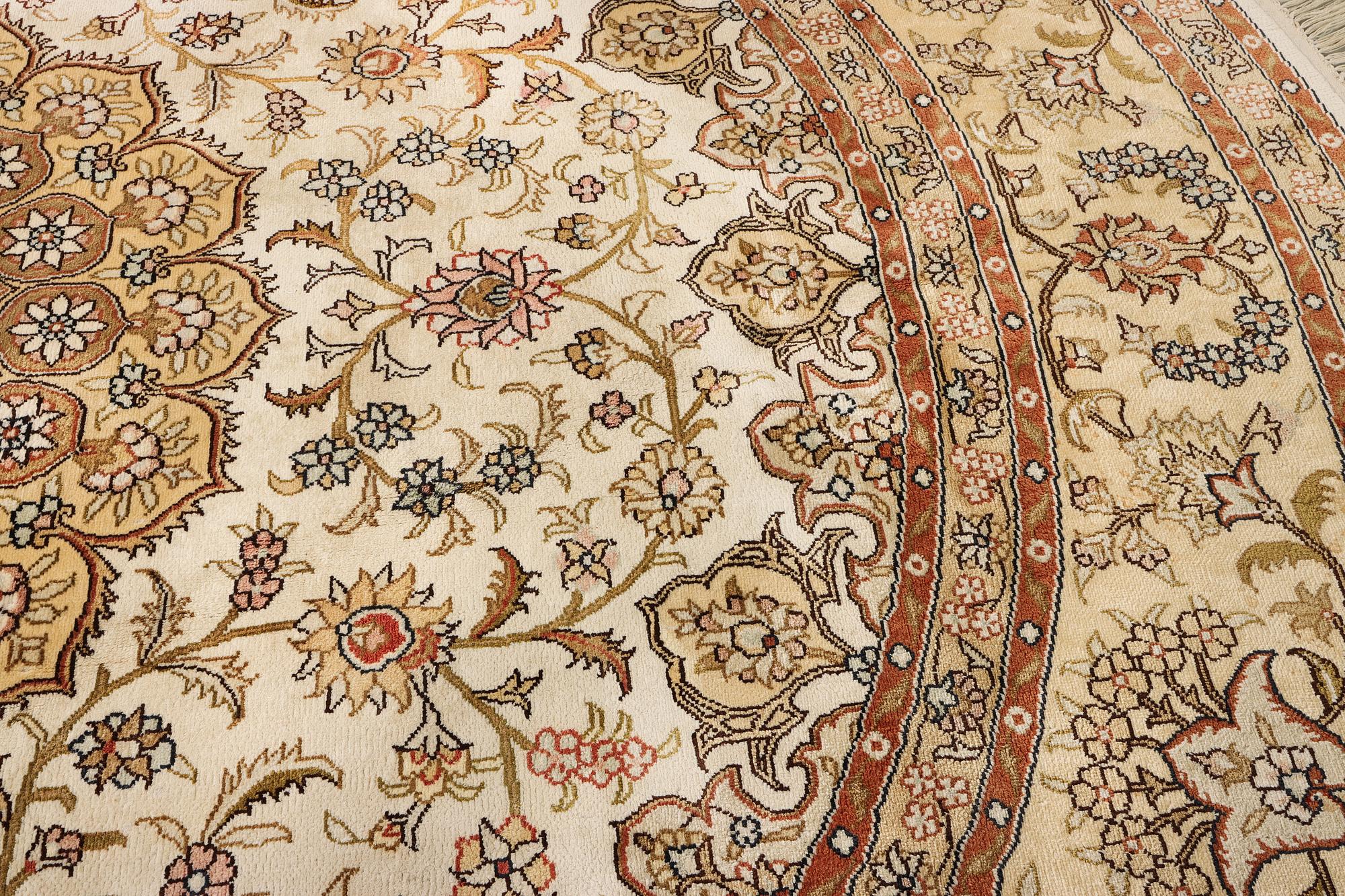 An oriental silk rug, diameter c. 216 cm.