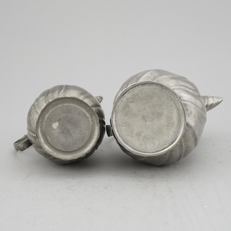 A pair of rococo style pewter coffee pots, from around year 1900.