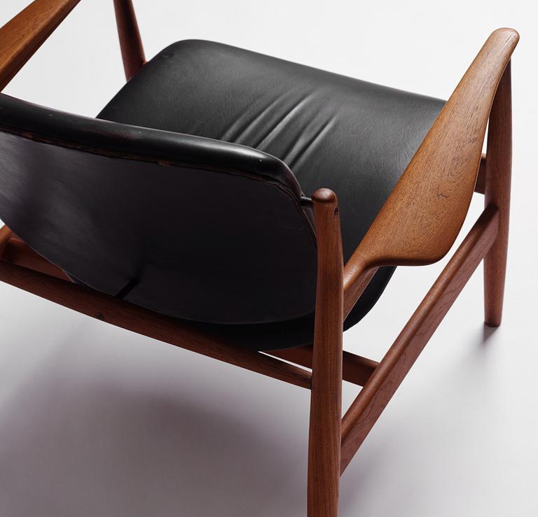 Finn Juhl, a teak and black leather 'model 136' easy chair, France & Daverkosen, Denmark 1950-60s.