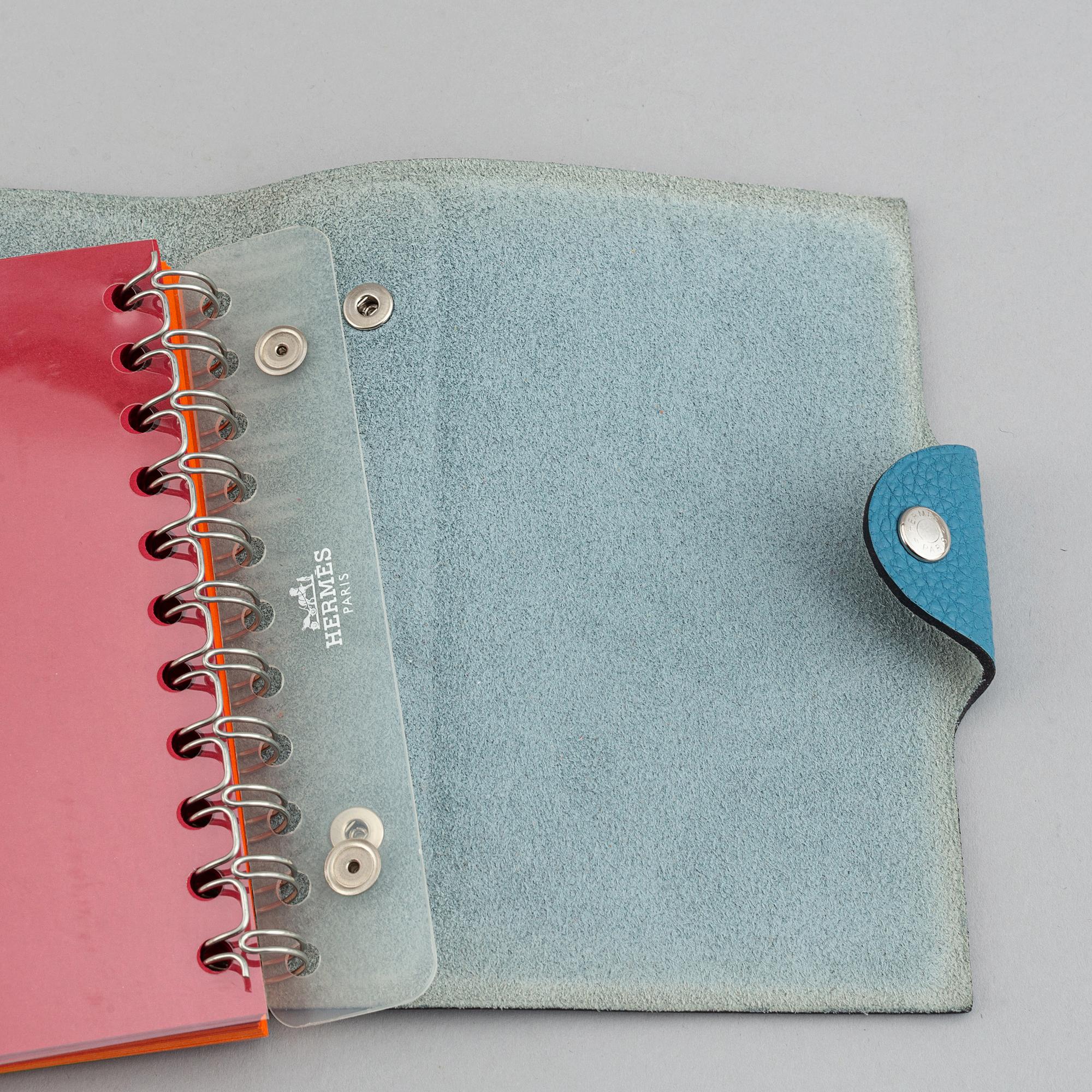 Hermès, a blue leather notebook with two scripple pads.