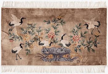 A silke figural rug, China, later part of the 20th century, ca. 92 x 170 cm.
