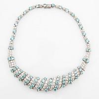 Necklace and earrings in 18K white gold with faceted zircons.