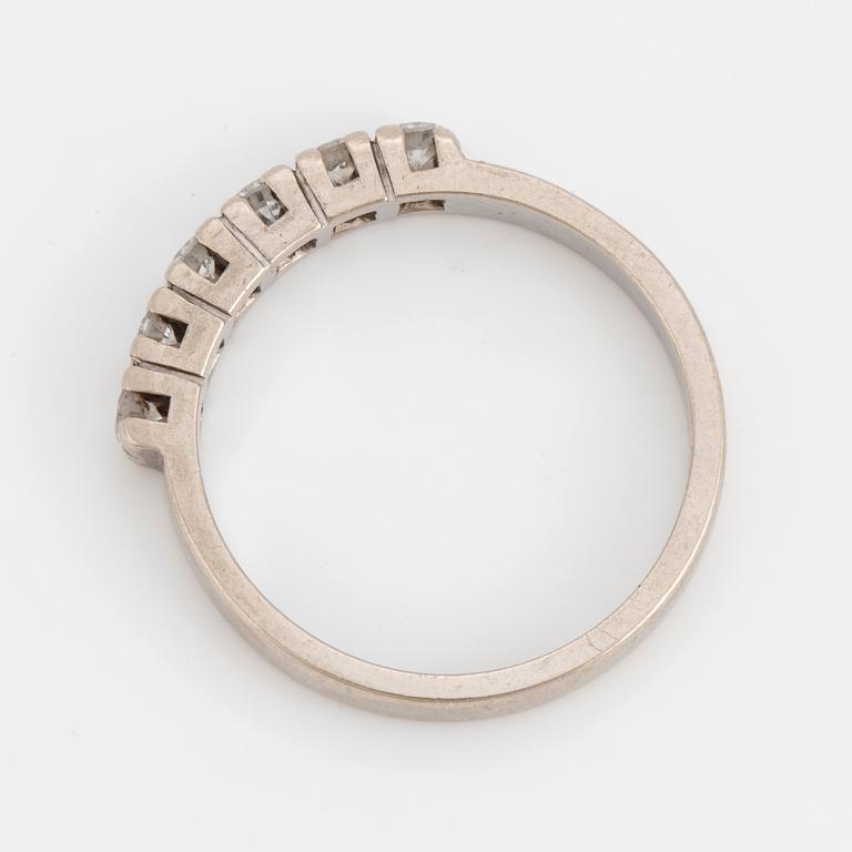 A ring set with six, round, brilliant-cut diamonds.