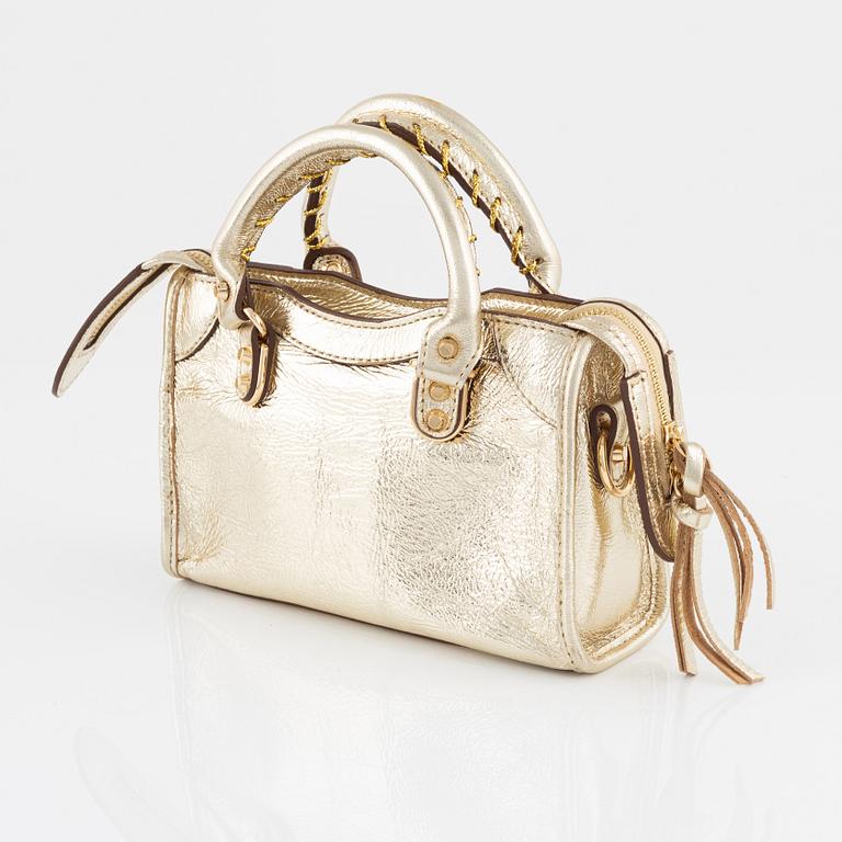 Balenciaga, a gold leather 'Classic City Mini Bag'.