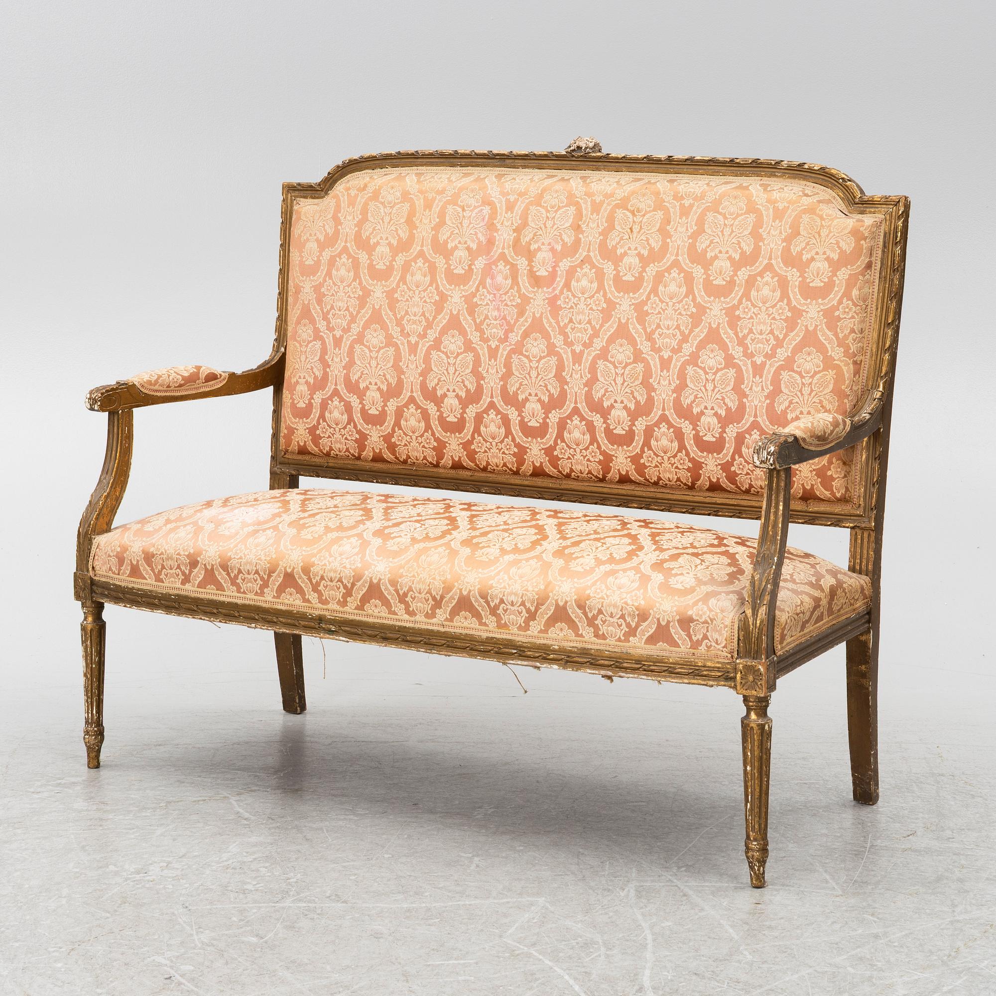 A pair of Louis XVI-style armchairs and a sofa, 20th century.