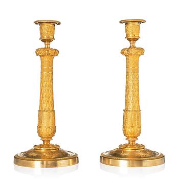 141. A pair of French Empire candlesticks.