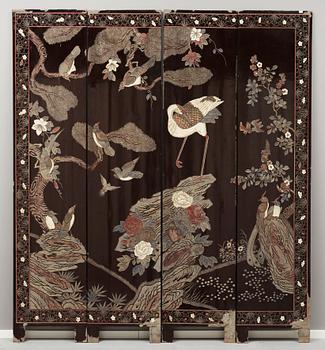 A coromandel black-lacquer four panel screen, Qing Dynasty (1644-1912).