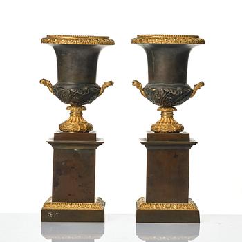 A pair of French Louis Philippe gilt and patinated bronze urns, first part 19th century.