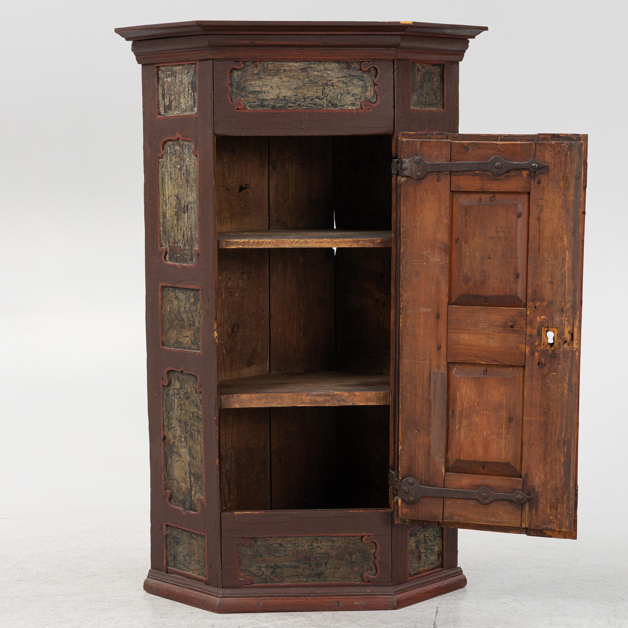 A corner cabinet, 18th Century.