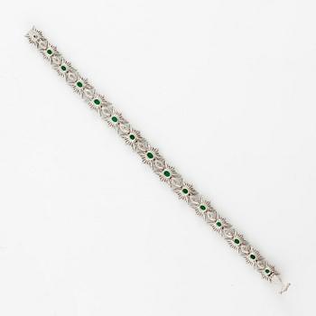 A bracelet in 18K white gold with step-cut emeralds and round and navette-shaped brilliant-cut diamonds.