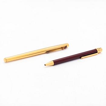 Two pens by Cartier and Caran d'Ache.