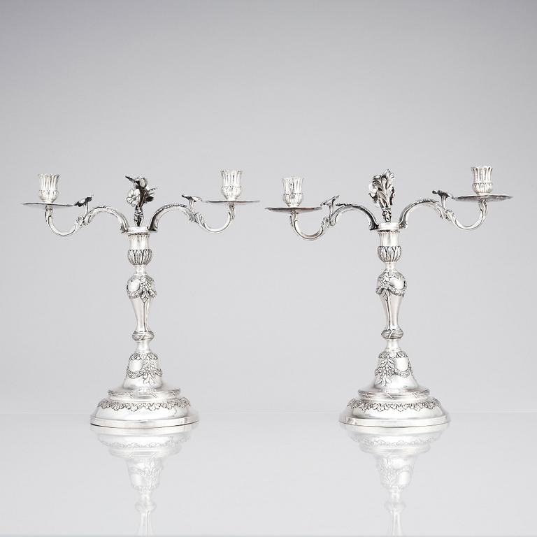 A pair of Swedish 18 century silver candelabras, mark of Lars Åkerblom Gävle 1775, arms by Christian Kullberg.