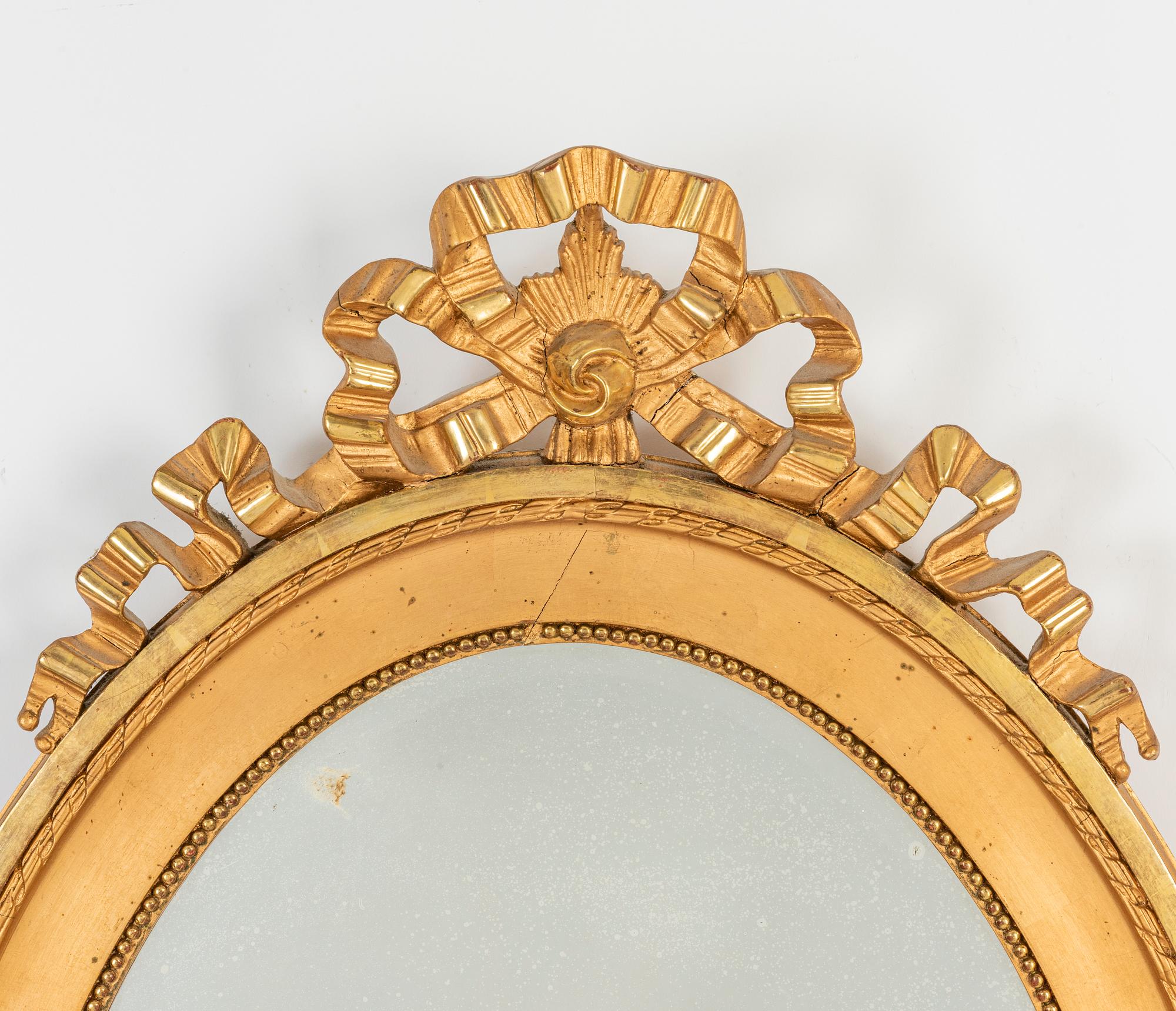 An oval Gustavian style mirror, early 20th Century.