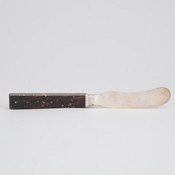 A silver butterknife with porphyry shaft, dated 1853.