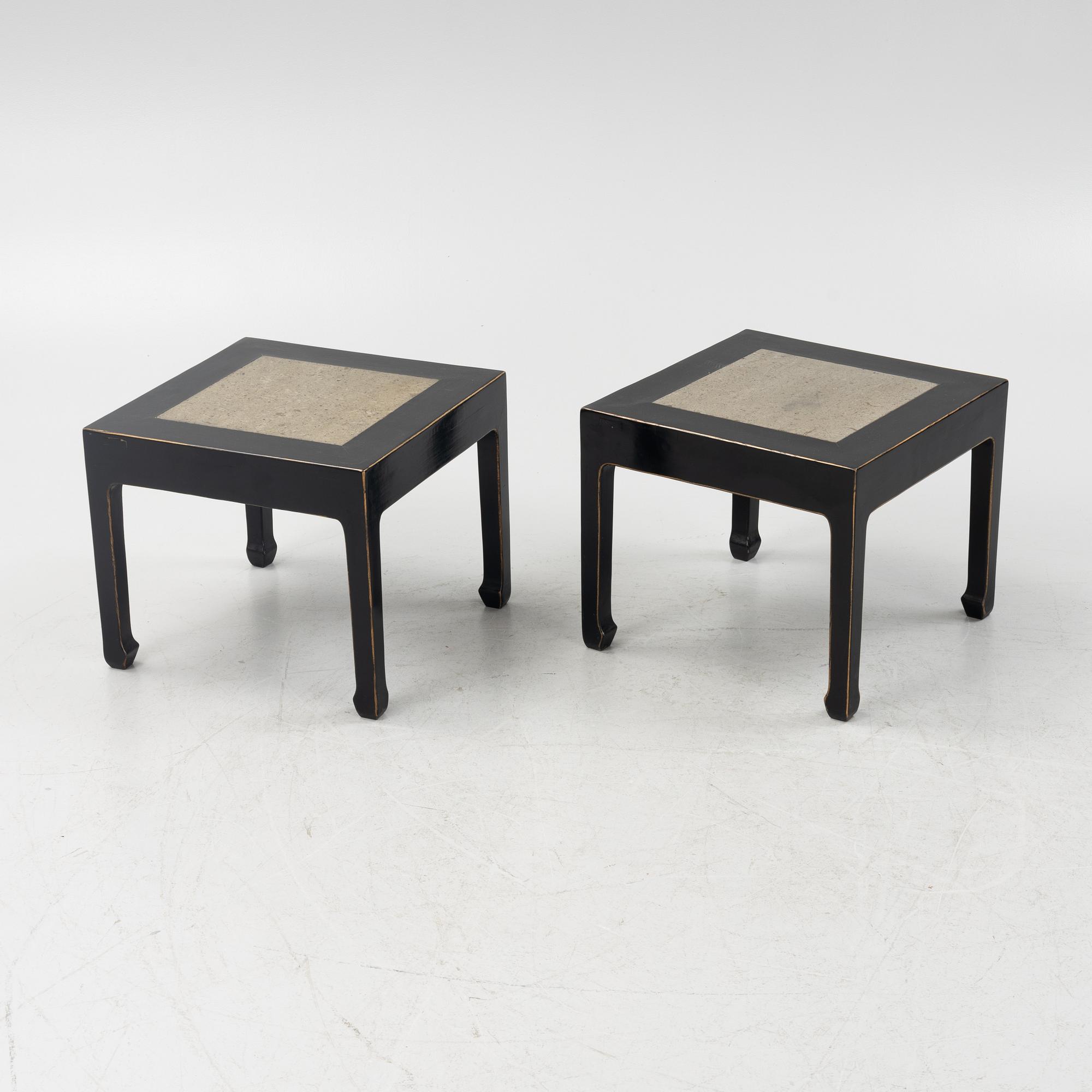 A pair of blac painted side tables with stone tops.