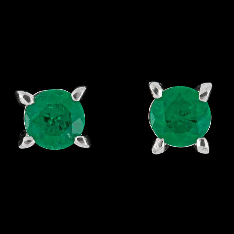 A pair of emerald earrings.