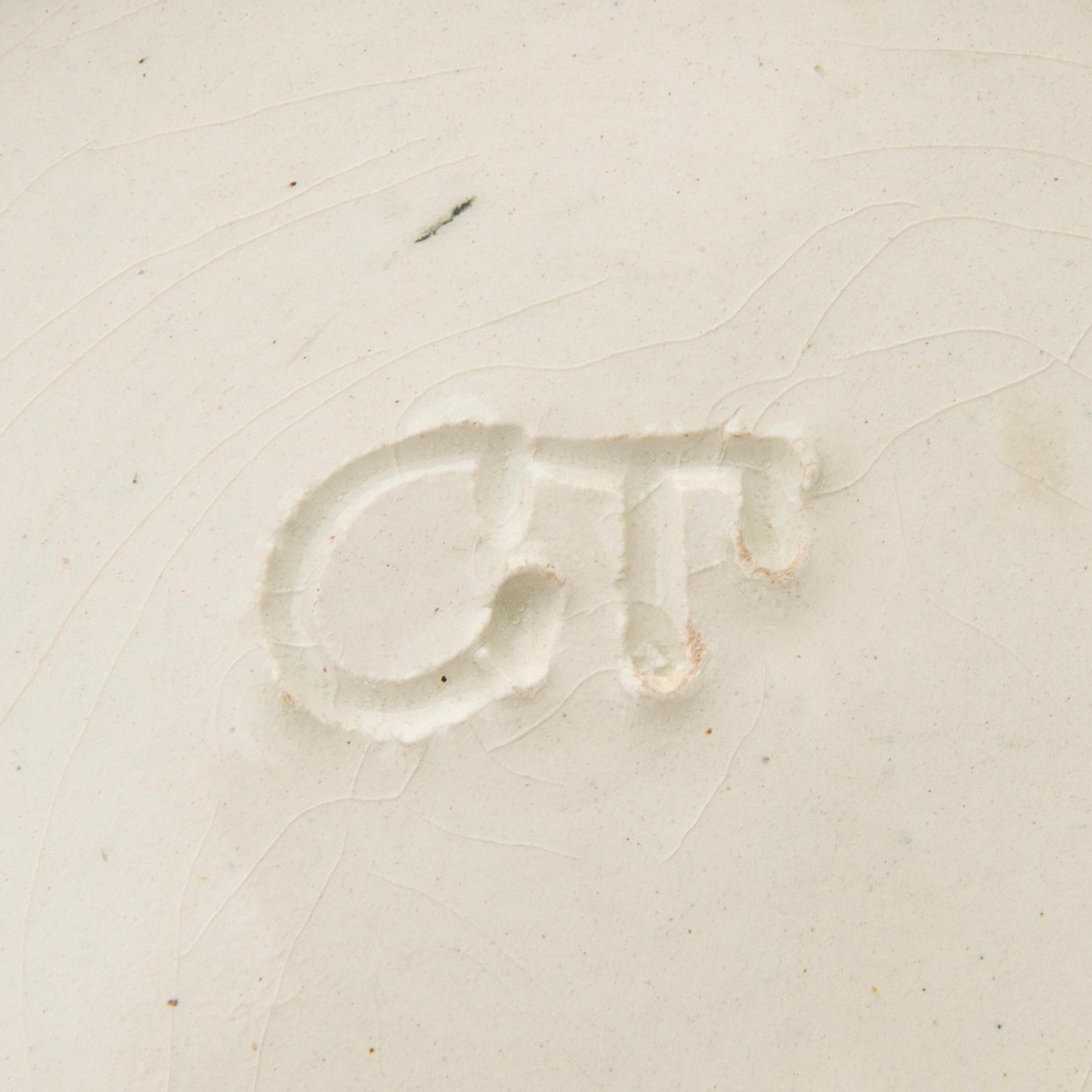 A ceramic bowl signed GT.