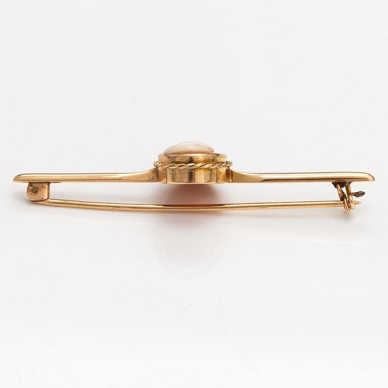 Two brooches and a ring, 14K and 18K gold and sea shell cameos.
