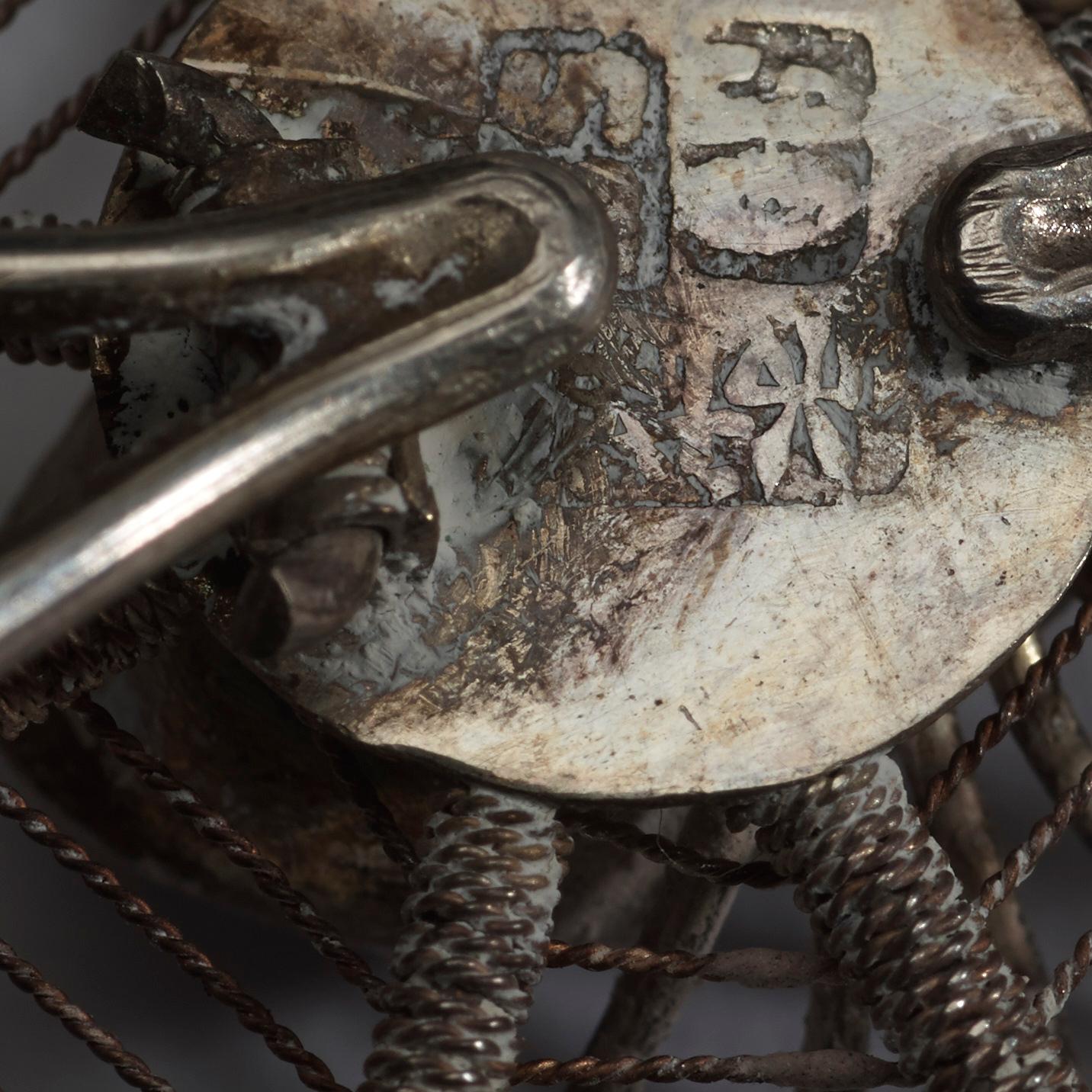 A set of fourteen Chinese silver place card holders, makers mark by Sing Fat, Canton, early 20th Century.