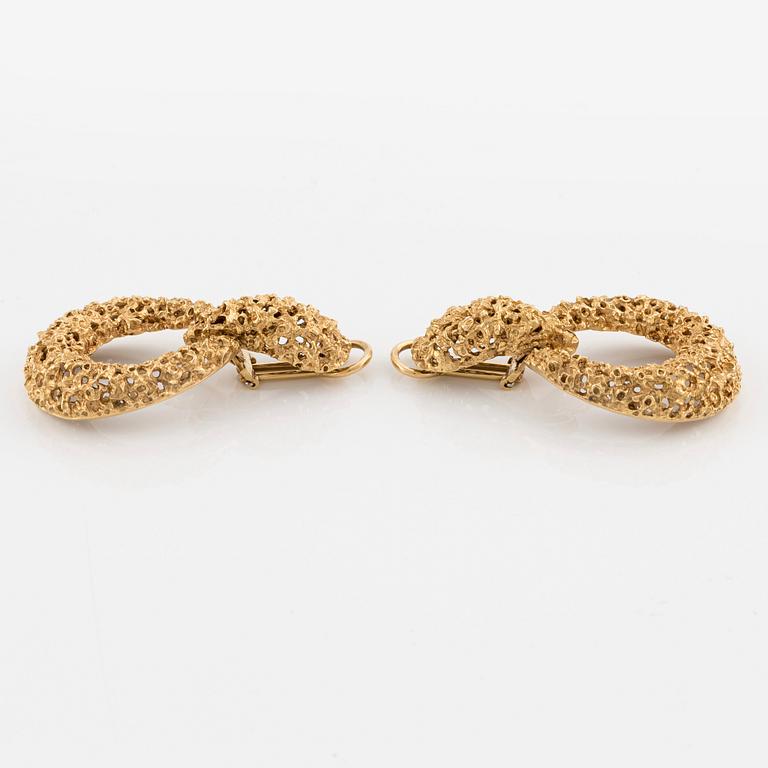 A pair of 18K gold earrings.