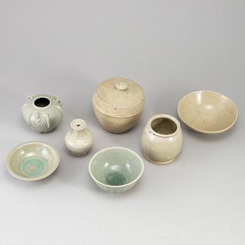 A group of seven pale olive green South East Asian ceramics, songstyle, 20th Century.