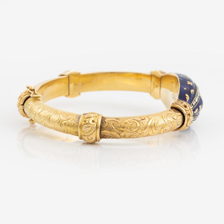 A bangle, gold, blue enamel, and rose cut diamonds.