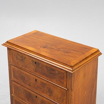 A walnut-veneered dresser, around 1900.