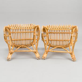 A pair of rattan arm chairs from the latter half of the 20th Century.