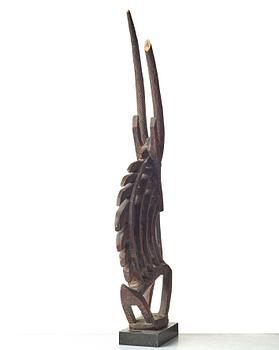 A SCULPTURE, a headdress, Tshiwara/Ciwara (stylized male antelope), wood, the Bambara tribe, Mali, h. 94 cm. On a base.