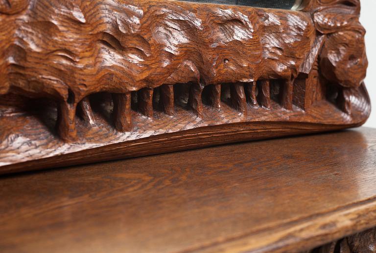 An Art Nouveau oak wall mirror with a console table.