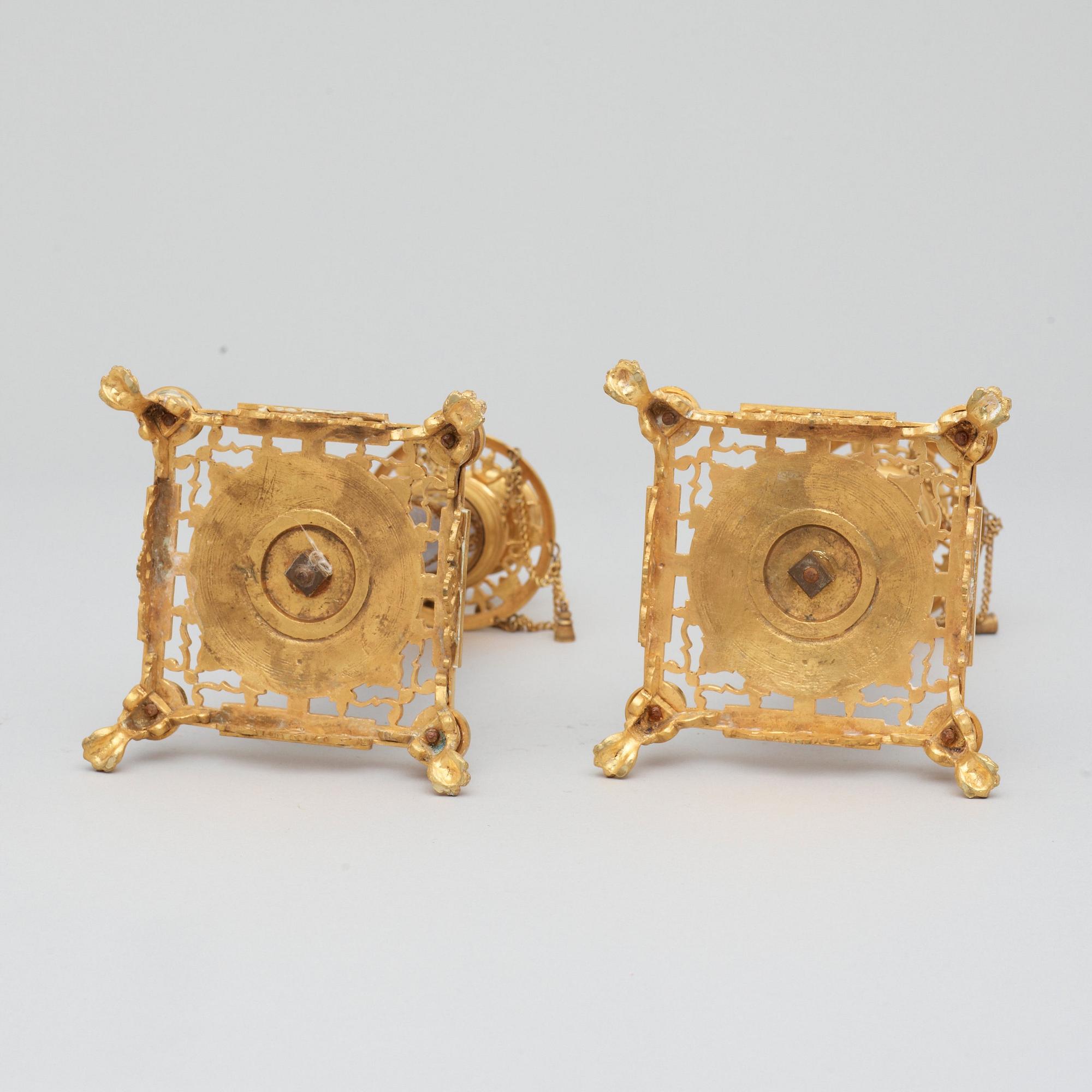 A pair of Swedish late 19th century brass and porphyry-imitation glass candlesticks.