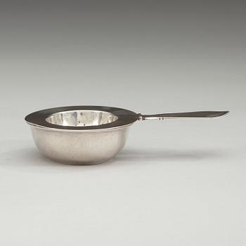A Georg Jensen sterling tea strainer with its bowl, Copenhagen 1920's and 1933-44.