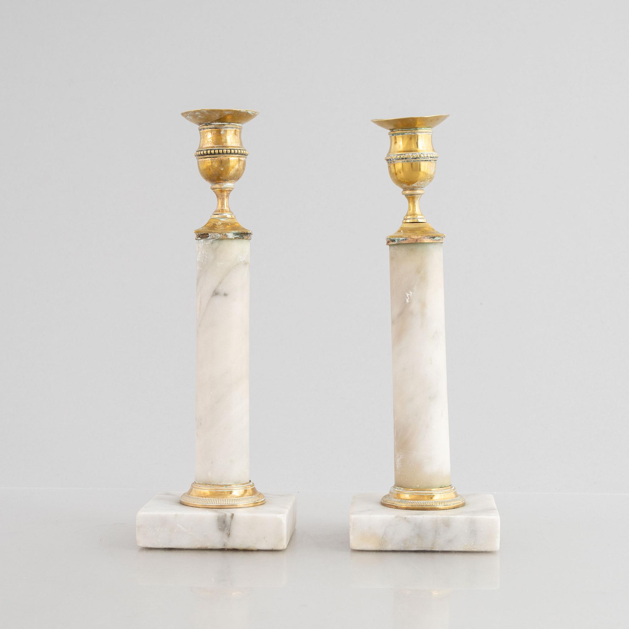A pair of Gustavian gilt brass and marble candlesticks, late 18th century.