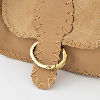 Gucci, a suede handbag.