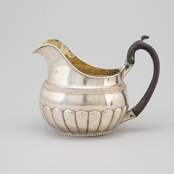 A Russian Empire parcel-gilt cream jug, maker's mark Elias Modig (1795-1834), St Petersburg, 1824.