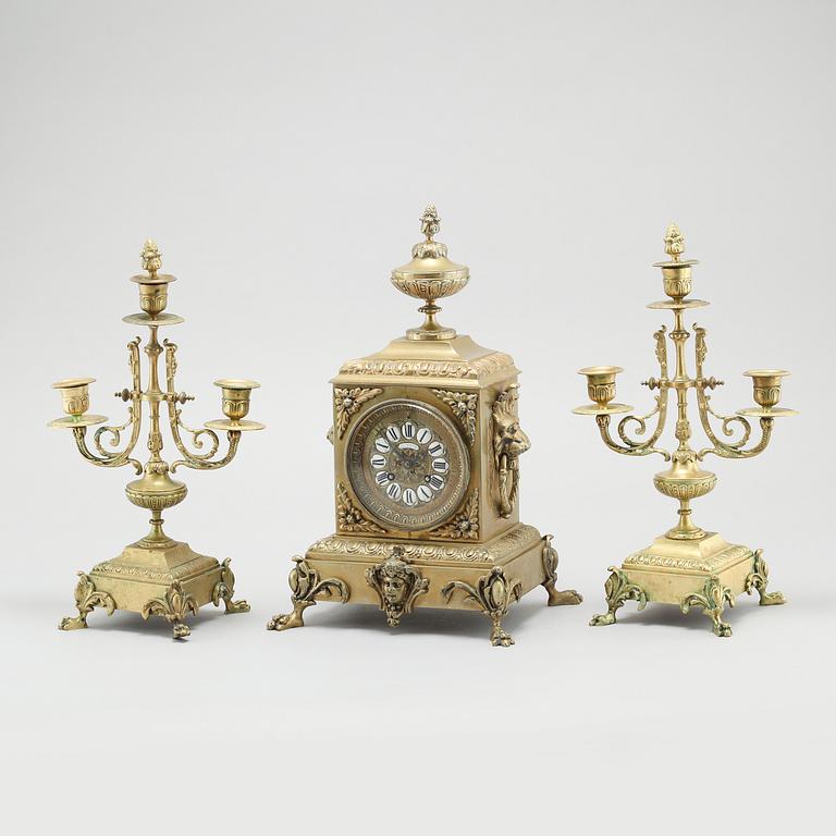 A table clock and two candelabras, around the year 1900.
