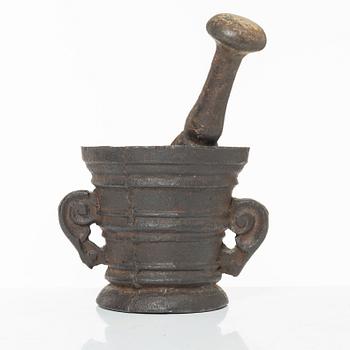 A cast-iron mortar and pestle of renaissance-type, 17th century.
