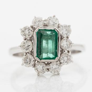Ring 18K white gold set with a step-cut emerald and round brilliant-cut diamonds.