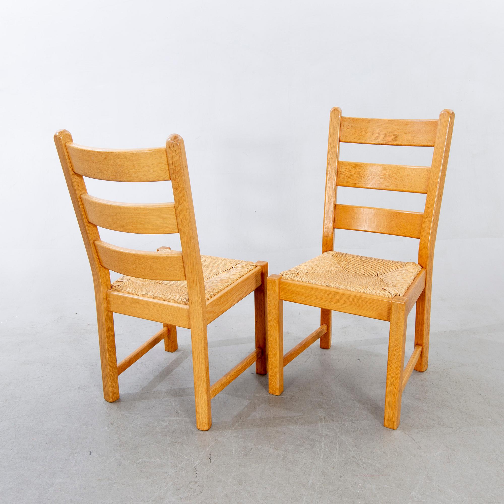 A set of four wicker and oak 1970s chairs.