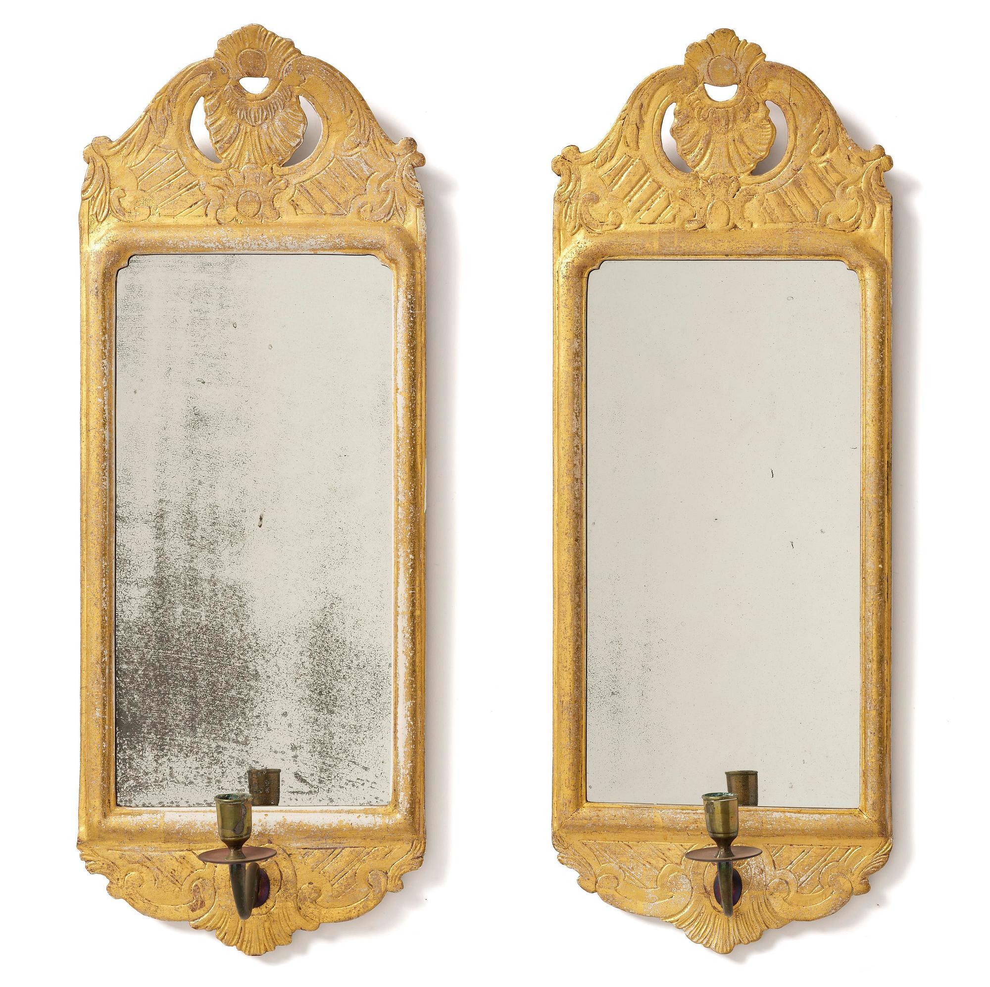 A matched pair of rococo giltwood one-branch girandole mirrors, Stockholm, late 18th century.