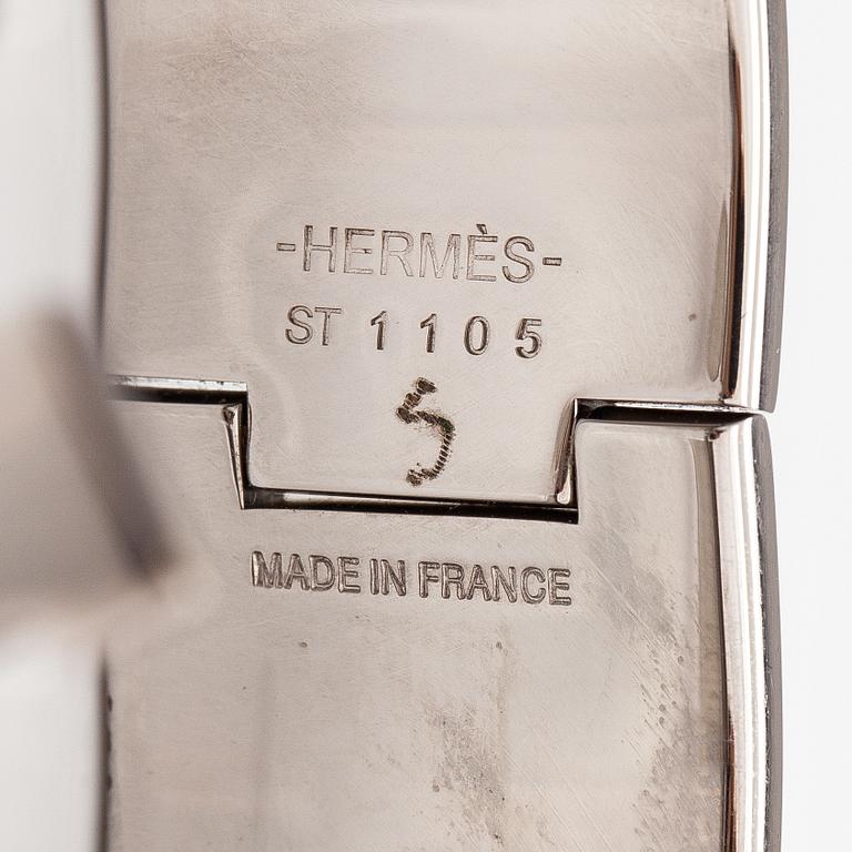Hermès, A "Click H" bracelet made of metal and yellow enamel. Marked Hermès, ST1105, S, Made in France.